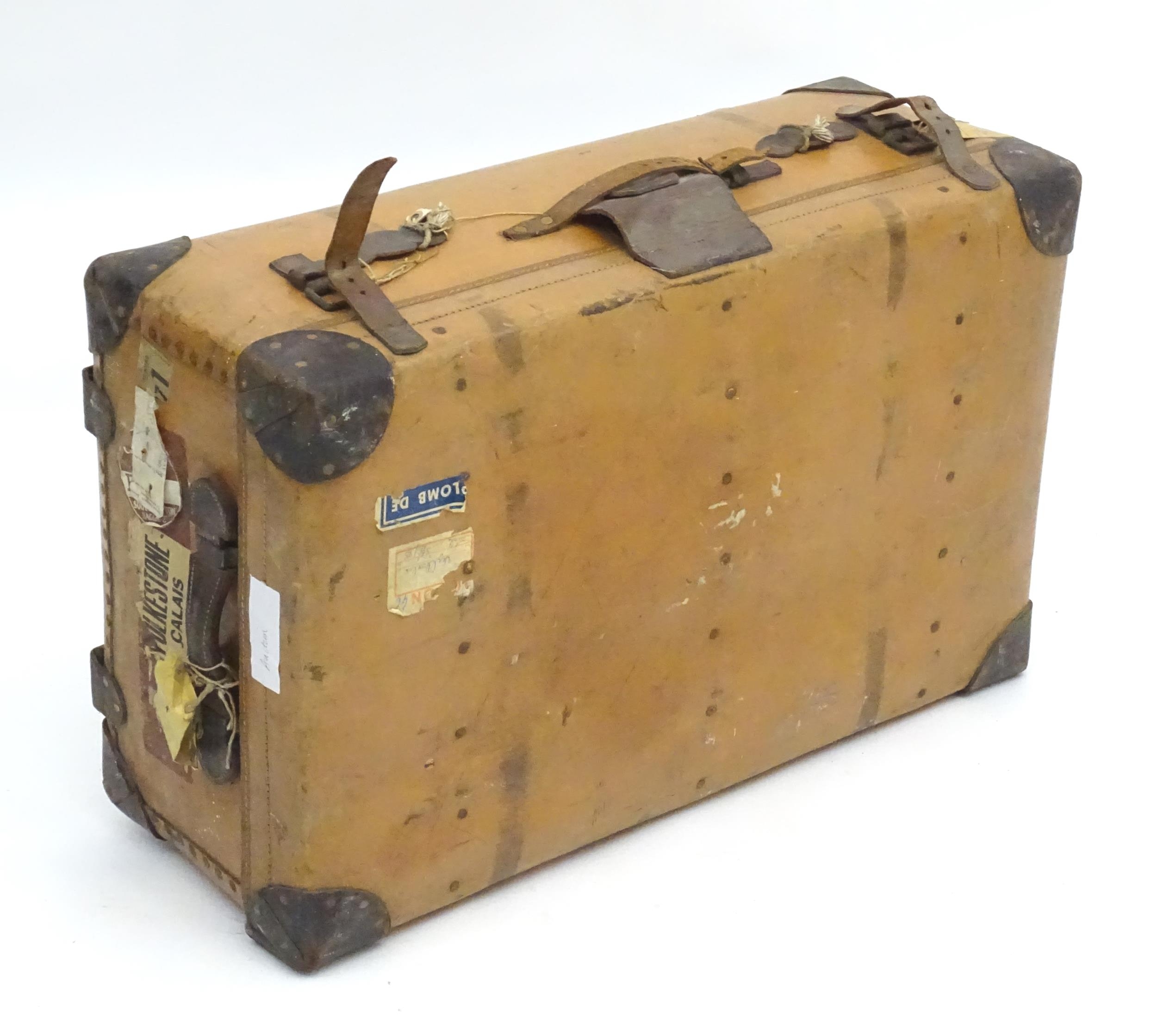 An early to mid 20thC canvas and leather travelling trunk / suitcase, in tan finish with partial