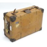 An early to mid 20thC canvas and leather travelling trunk / suitcase, in tan finish with partial