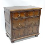 A 17thC style oak chest of drawers with three long drawers decorated with geometric motifs and