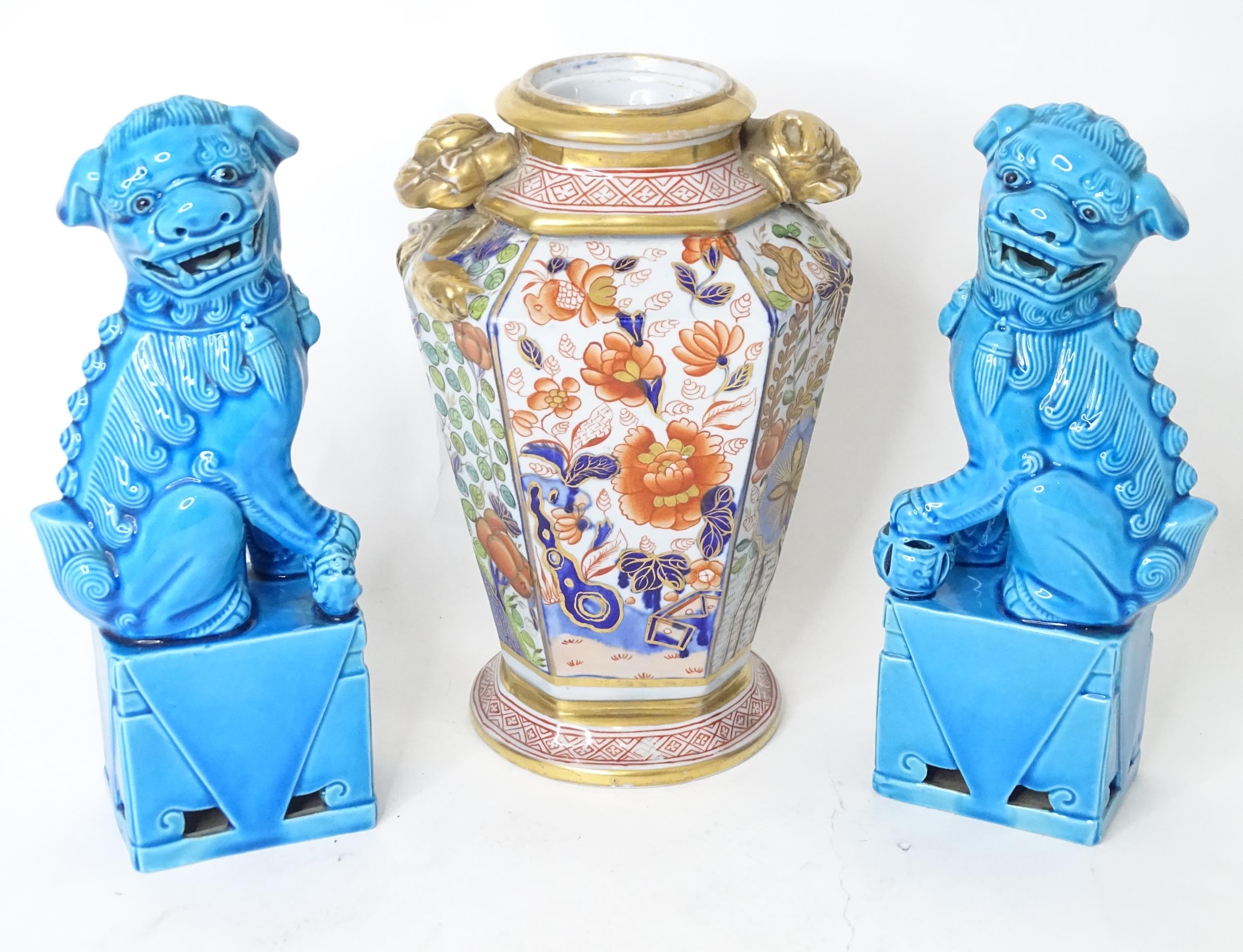 A pair of Chinese foo dogs with a turquoise glaze. Together with a twin handled vase with floral and