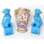 A pair of Chinese foo dogs with a turquoise glaze. Together with a twin handled vase with floral and
