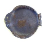 A studio pottery fish plate with a blue glaze, marked under Moulin Huet Pottery Guernsey. Approx. 11