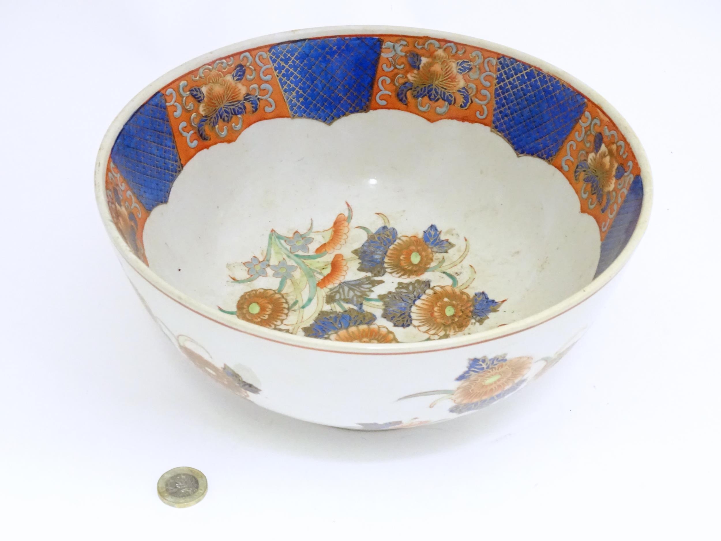 An Oriental bowl decorated with flowers and foliate in the Imari palette. Marked under. Approx. 4 - Image 3 of 6