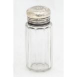 A cut glass dressing table bottle with silver top hallmarked London 1899, retailed by Drew & Sons.