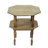 An early 20thC oak Arts and Crafts style occasional table with two octagonal tiers above shaped