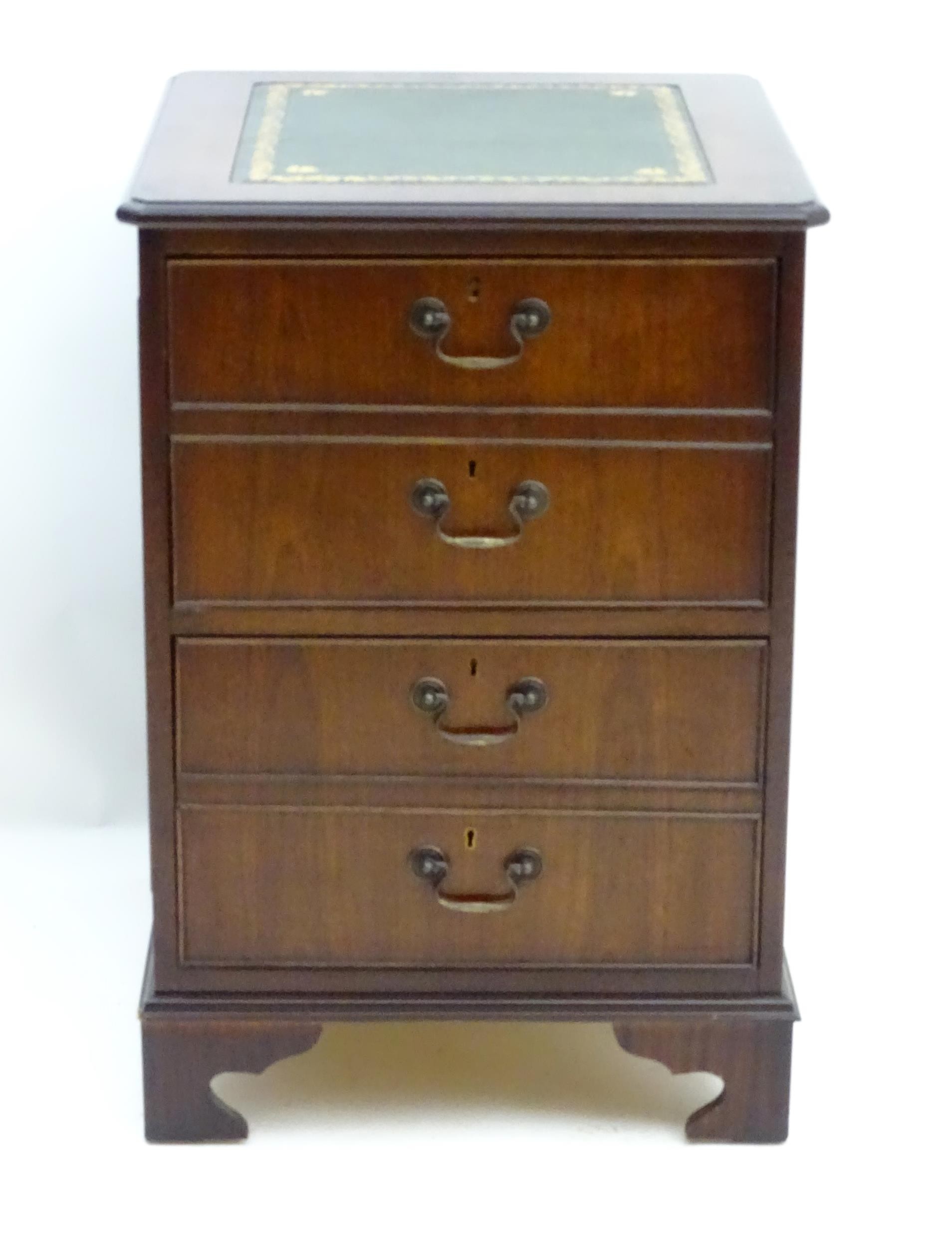 A mahogany leather topped filing cabinet / pedestal . Approx 30" high x 21" wide x 24" deep Please