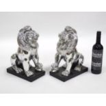 A pair of models of opposing seated lions. Approx. 14" high (2) Please Note - we do not make