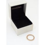 A silver gilt dress ring. With box marked Pandora. Please Note - we do not make reference to the