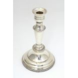 A silver plate candlestick. Approx 8" high Please Note - we do not make reference to the condition