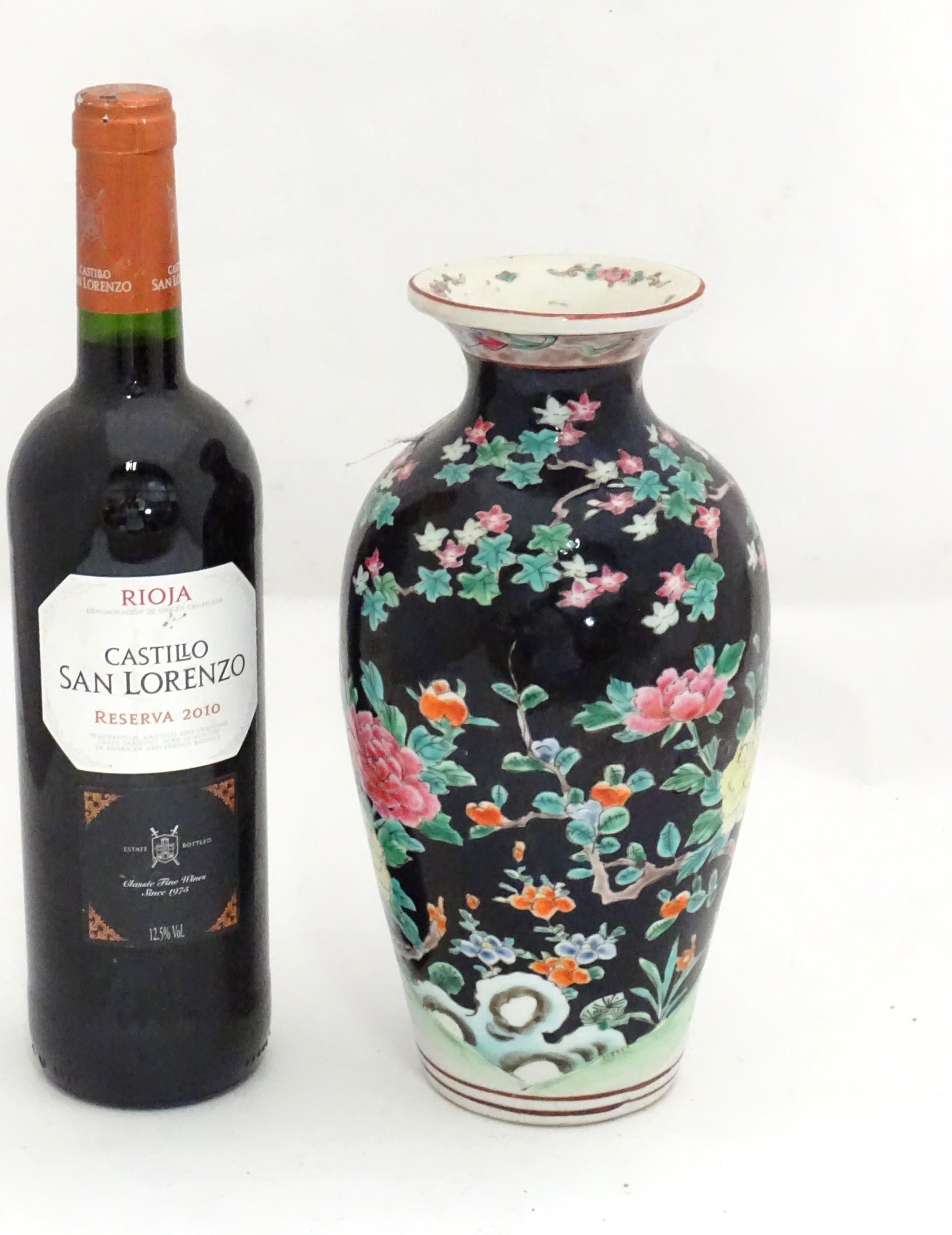 An Oriental vase decorated with a peacock in a landscape with flowers. Approx. 9 3/4" high Please - Image 3 of 3