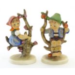 Two Hummel / Goebel figures comprising Apple Tree Girl, no. 141, and Apple Tree Boy, no. 142. Marked