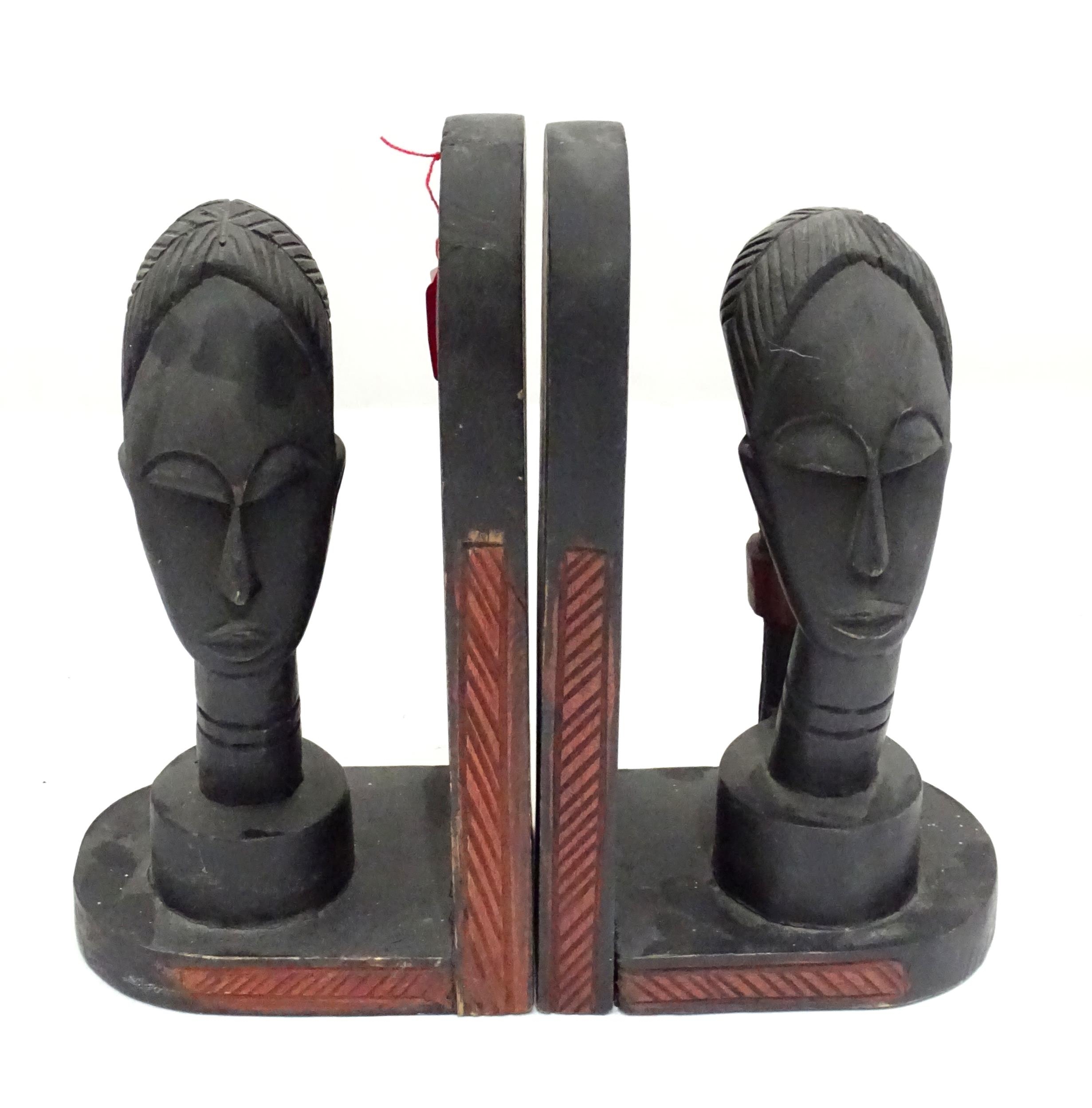 A pair of African carved hardwood bookends with figural head detail. Please Note - we do not make - Image 2 of 2