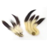 Two mid 20thC gilt metal brooches, each decorated with stoat / ermine tails, the largest 5" long