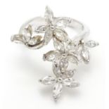 A silver dress ring with white stone decoration. Ring size approx O Please Note - we do not make