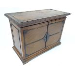 A 20thC mahogany smokers table cabinet, the interior with pipe rests and two drawers. Approx 17"