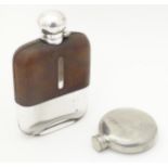 A glass hip flask with half leather covering 6" high together with a small pewter hip flask (2)