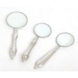 Three small magnifying glasses, the largest measuring 4 1/2" long approx (3) Please Note - we do not