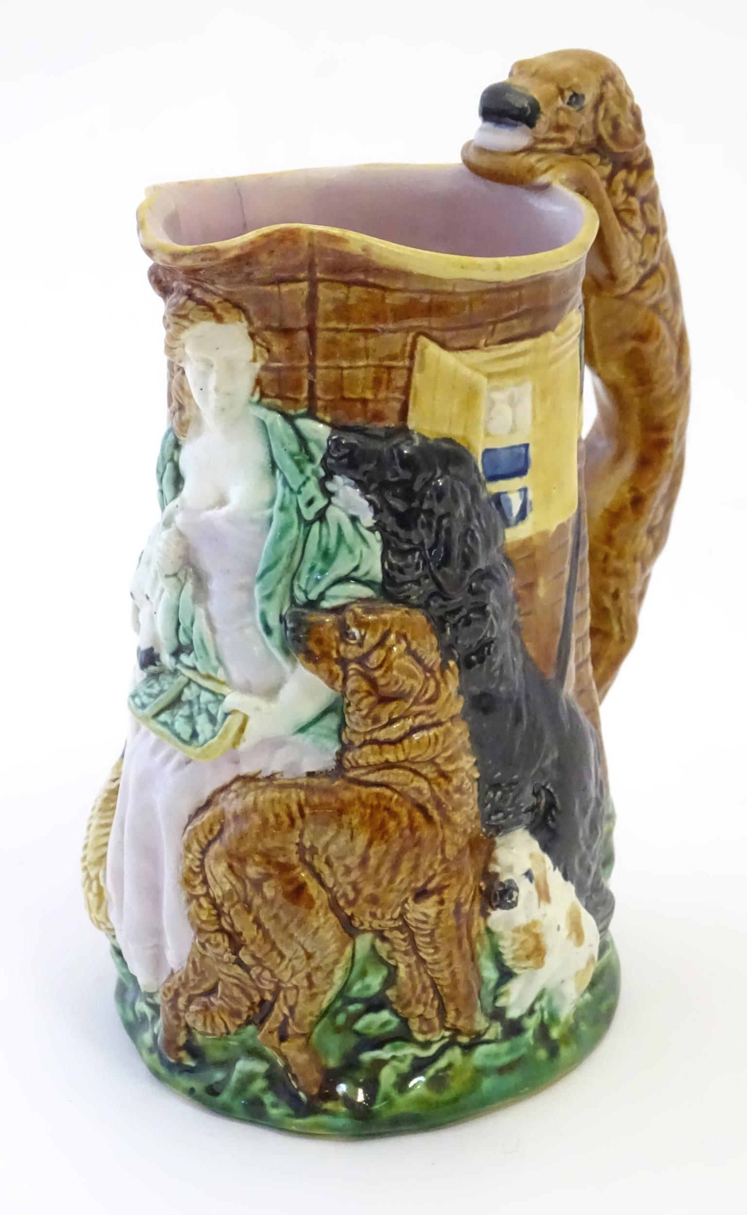 A Burleigh ware jug Old Feeding Time, with moulded relief decoration depicting a woman with dogs.