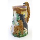 A Burleigh ware jug Old Feeding Time, with moulded relief decoration depicting a woman with dogs.