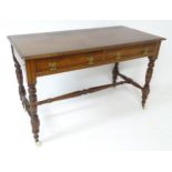 Mahogany aesthetic movement writing desk with moulded top above two short drawers and raised on four