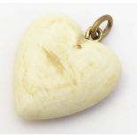 A carved bovine horn pendant of heart form. Approx 1 1/4" long. Please Note - we do not make
