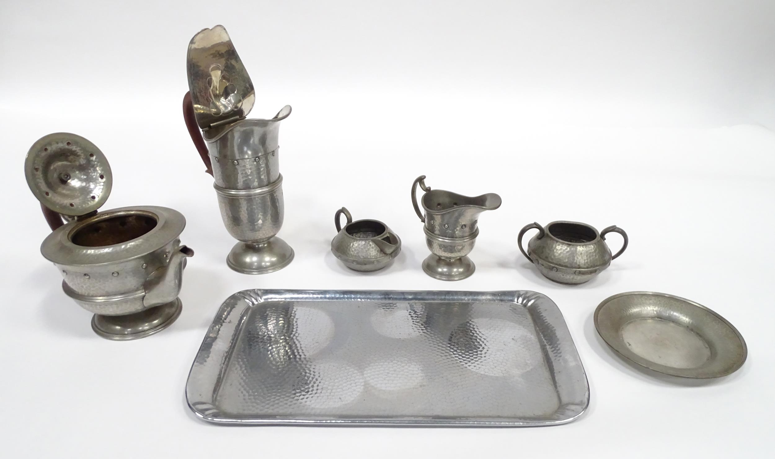 A quantity of Arts & Crafts style pewter tea wares with hammered decoration comprising teapot, - Image 8 of 18