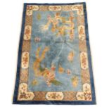 A Chinese rug, the blue ground decorated with dragons, bordered by further dragons and Oriental