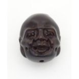 Carved Oriental ojime bead pendant. Approx 1" long Please Note - we do not make reference to the