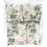 A pair of Colefax and Fowler curtains with a pale blue and green floral pattern. Each curtain