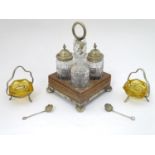 Two North Country shaped glass cruets with silver plate 3 legged stands and loop handle with