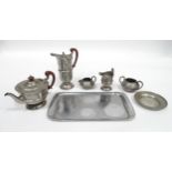 A quantity of Arts & Crafts style pewter tea wares with hammered decoration comprising teapot,