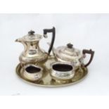 A 4-piece silver plate tea set. Together with an oval silver plated tray. The tray 16" wide. (5)