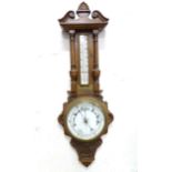 An early 20thC aneroid barometer with oak case, 34" tall Please Note - we do not make reference to