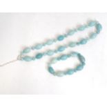 A jade coloured bead necklace together with a matching bracelet. The necklace approx. 18" long (2)