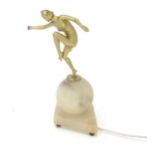 An Art Deco lamp with an alabaster base surmounted by a dancer. Approx. 12" high Please Note - we do