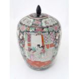 An Oriental pot and cover decorated with figures on a terrace, birds amongst flowers and foliage,