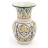A 20thC Continental baluster vase with a flared rim decorated with hand painted Arts & Crafts