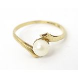 A 9ct gold ring set with single pearl. Rings size approx S 1/2 Please Note - we do not make