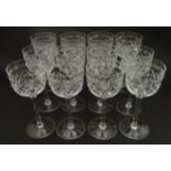 A set of twelve pedestal drinking glasses with cut decoration, by Tudor Crystal. Approx. 7" high (