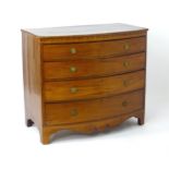 An early / mid 19thC bow fronted mahogany chest of drawers, having a satinwood inlaid frame and four