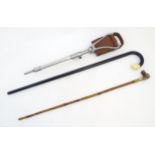 Two 20thC walking sticks / canes comprising an ebonised walking stick the handle modelled as a boxer