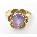 A 9ct gold ring set with central amethyst. Ring size approx. O 1/2 Please Note - we do not make