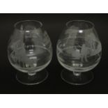 Two drinking glasses / brandy glasses, one with engraved decoration depicting a fisherman, the other