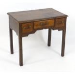 An 18thC mahogany lowboy with a moulded top above three short drawers with Chippendale style