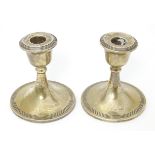 A pair of short silver candlesticks hallmarked Chester 1913, maker S. Blanckensee & Son Ltd. Approx.