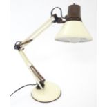 An adjustable desk lamp in cream and brown livery in the Anglepoise style, marked under Patent
