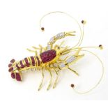 A charming 18ct gold diamond and ruby pendant / brooch formed as a lobster with articulated claws,
