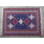 Carpet / rug : An Afghan fine weave rug having a blue ground with central red and cream