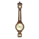 A mahogany barometer surmounted by twin dolphins and signed ' J Wrench 6 Grays Inn Terrace London.