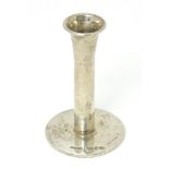 A silver taper stick holder on a circular base hallmarked Chester 1904, maker Sampson Mordan &